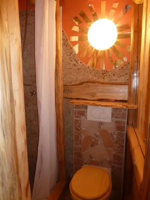 a small bathroom with a toilet and a mirror at ARTHARMONY Pension & Hostel in Prague
