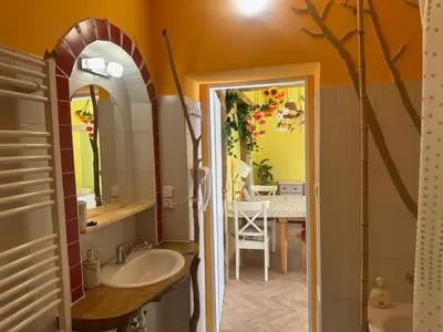 a bathroom with a sink and a mirror at ARTHARMONY Pension & Hostel in Prague