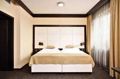 a bedroom with a large bed with a large window at Hotel Lifestyle in Prague