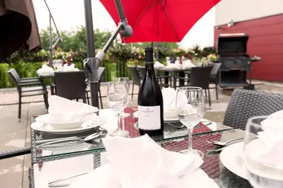 a bottle of wine sitting on a table with glasses at Hotel Lifestyle in Prague