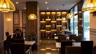 a dining room with tables and chairs and chandeliers at Hotel Lifestyle in Prague