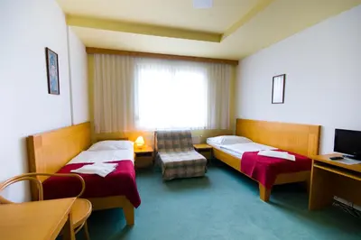 a hotel room with two beds and a window at Hotel Smaragd in Prague
