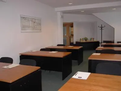 a room with desks and chairs in a room at Hotel Smaragd in Prague