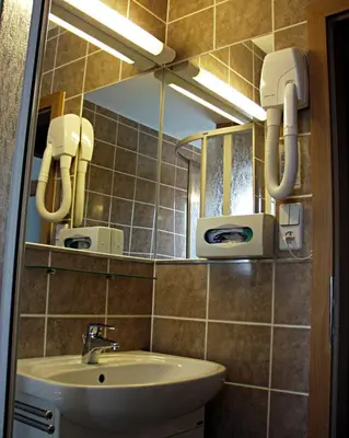 a bathroom with a sink and a mirror at Hotel Smaragd in Prague