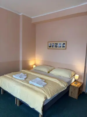 a bedroom with a bed with two towels on it at Hotel Koruna in Roudnice nad Labem
