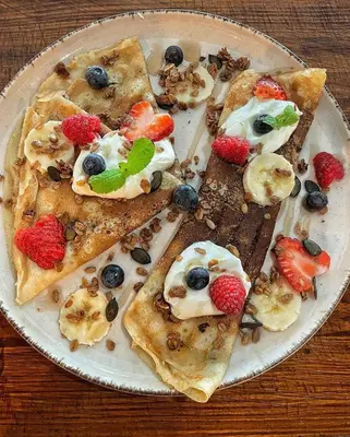 a plate with slices of pizza with fruit on it at Hotel Koruna in Roudnice nad Labem