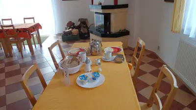 a dining room table with a wooden table and chairs at Pension Camp Prager in Prague
