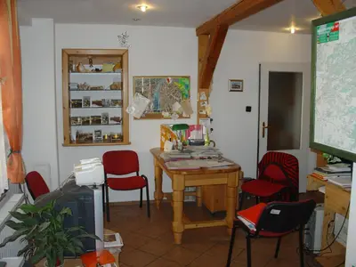 a classroom with a table and red chairs and a screen at Pension Camp Prager in Prague