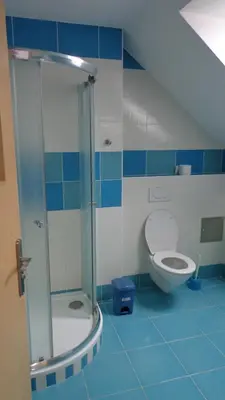a bathroom with a toilet and a glass shower at Pension Camp Prager in Prague