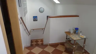 a hallway with stairs and a table in a room at Pension Camp Prager in Prague