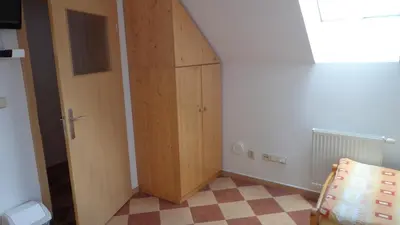 a wooden door in a room with a checkered floor at Pension Camp Prager in Prague