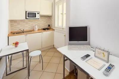 a kitchen with a laptop computer on a counter at Dušní Apartments in Prague