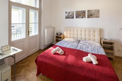 a bedroom with a large bed with two towels on it at Dušní Apartments in Prague