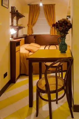 a table and a chair in a room with a bed at Residence Týnská in Prague