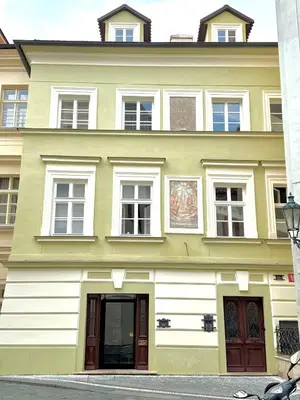 a large yellow and white building with windows at Residence Týnská in Prague