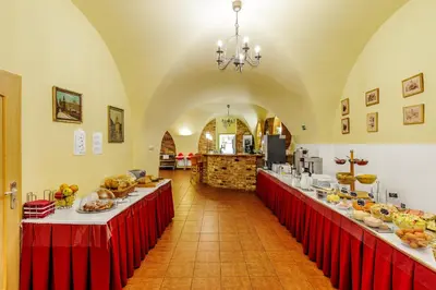a large room with two long tables filled with food at Hotel STARÝ PIVOVAR in Prague