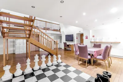 a living room with a chess board and a staircase at Hotel STARÝ PIVOVAR in Prague
