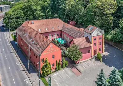 an overhead view of a large pink house at Hotel STARÝ PIVOVAR in Prague