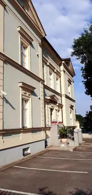 a large white building with windows on a street at Penzion U sv. Kryštofa in Prague