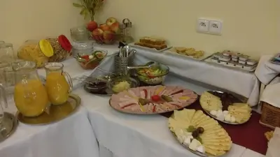 a white table with plates of food on it at Penzion U sv. Kryštofa in Prague