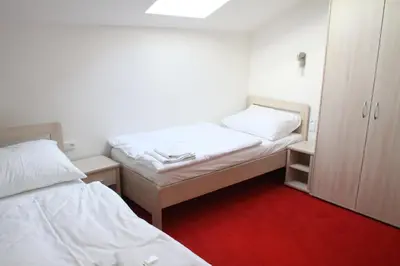 a small room with two beds and a cabinet at Penzion U sv. Kryštofa in Prague