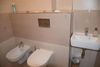 a bathroom with a toilet and a sink at Tiva Downtown Apartments in Prague