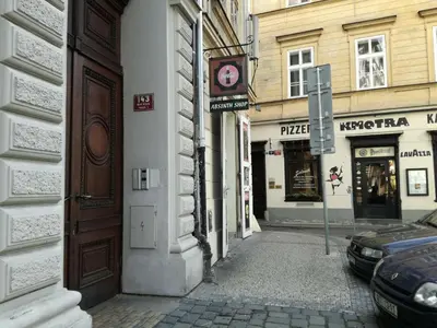 an alley with a clock on the side of a building at Tiva Downtown Apartments in Prague