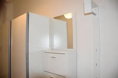 a white cabinet with a mirror on top of it at Tiva Downtown Apartments in Prague