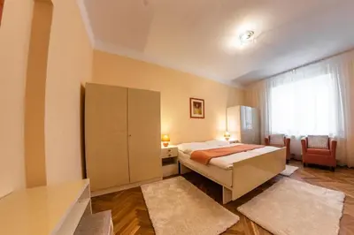 a bedroom with a bed and a cabinet and a window at Villa A. Malka in Poděbrady