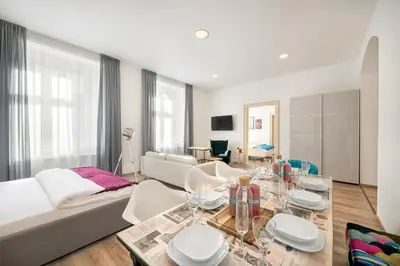 a bedroom with a large bed and a couch at Prague Days - Family Friendly Three-bedroom Apartment in trendy Karlín in Prague