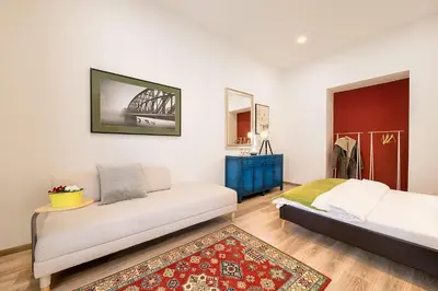a white bath tub in a bathroom with a window at Prague Days - Family Friendly Three-bedroom Apartment in trendy Karlín in Prague