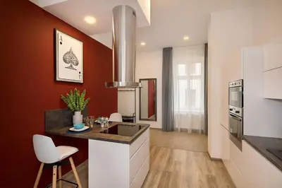 a bedroom with a large white bed and a window at Prague Days - Family Friendly Three-bedroom Apartment in trendy Karlín in Prague