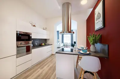 a bathroom with two sinks and two vases with plants at Prague Days - Family Friendly Three-bedroom Apartment in trendy Karlín in Prague