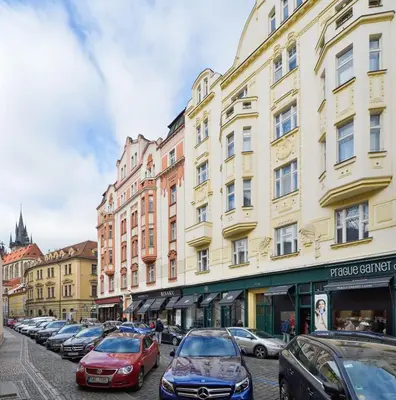 a row of cars parked in front of buildings at Art Nouveau Residence in Prague