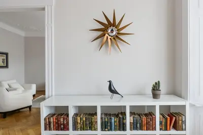 a living room with a white book shelf filled with books at Art Nouveau Residence in Prague