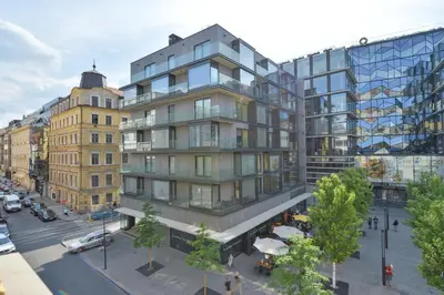 a rendering of a tall building on a city street at Kafka's Head Apartment in Prague