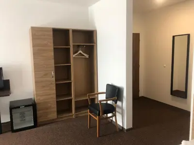 a room with a desk and a chair and a mirror at Motel R10 in Mladá Boleslav