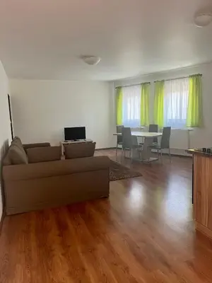 a living room with a couch and a table with a laptop at Motel R10 in Mladá Boleslav