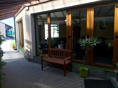 a wooden bench sitting in front of a building at Motel R10 in Mladá Boleslav