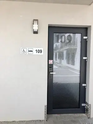 a black door with a sign on the side of a building at Motel R10 in Mladá Boleslav