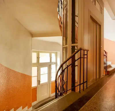 a staircase in a building with a window at Cozy Private Apartment in Prague