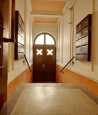 a hallway with a door with a window at Cozy Private Apartment in Prague