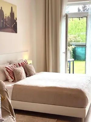 a bedroom with a large bed with a window at Maria Apartments - Free Parking in Prague