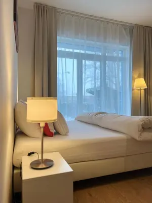 a bedroom with a bed with a large window at Maria Apartments - Free Parking in Prague
