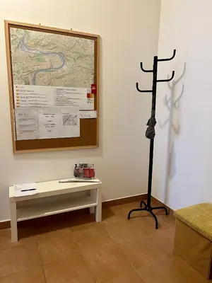 a tripod in a room with a bench and a map at Maria Apartments - Free Parking in Prague
