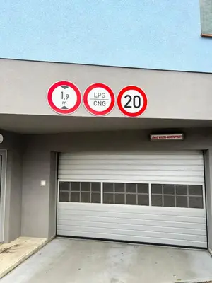 a garage door with four signs on top of it at Maria Apartments - Free Parking in Prague