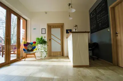 a room with a chalkboard and a table and a chair at Penzion Na Americe in Nové Jirny