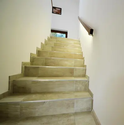 a staircase in a house with concrete steps at Penzion Na Americe in Nové Jirny