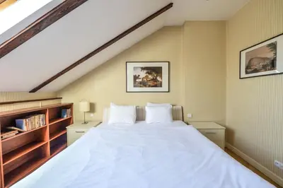 a bedroom with a large white bed in a attic at Panoramic Loft in Prague
