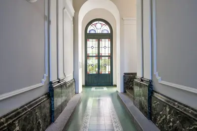 a hallway with a door and a stained glass window at Panoramic Loft in Prague
